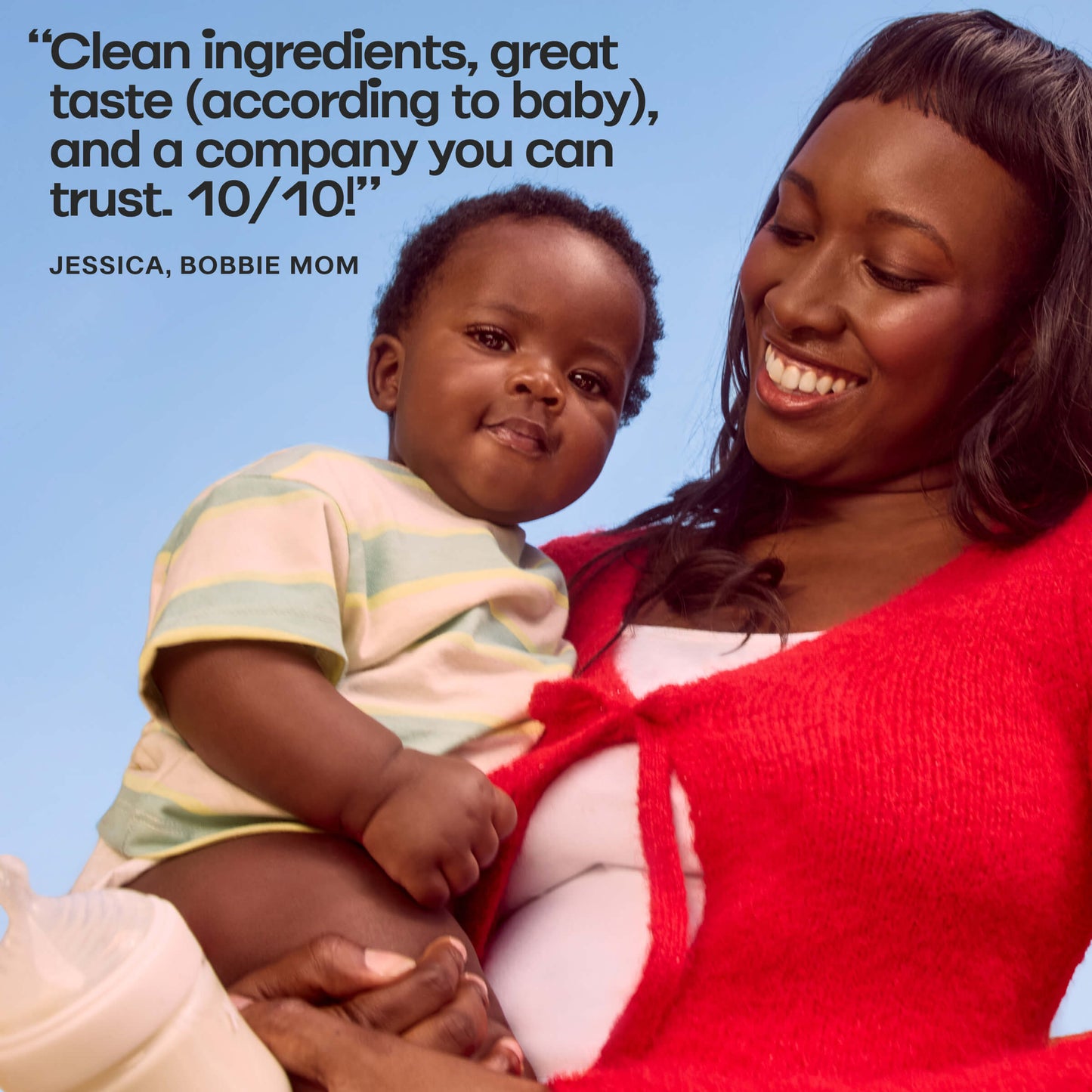 Bobbie mom holding a baby with a blue background and text about clean ingredients and trust.